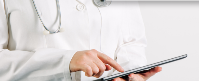 A healthcare professional using a tablet.